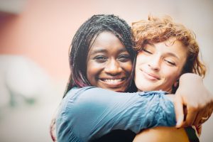 African woman supporting her Caucasian girlfriend